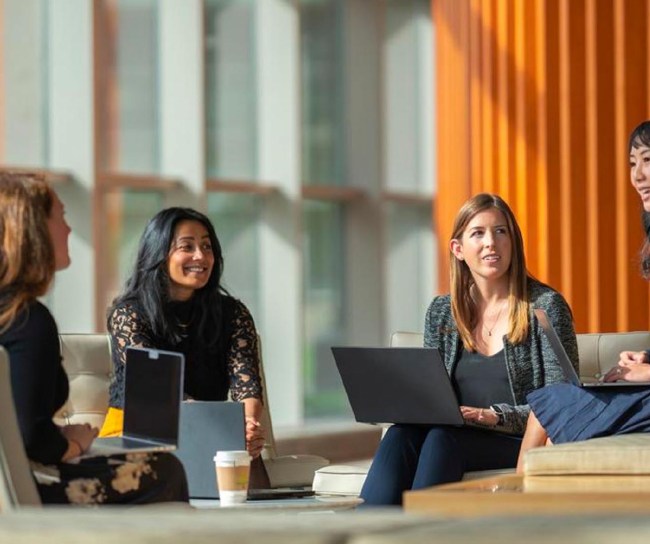four women are meeting in a building