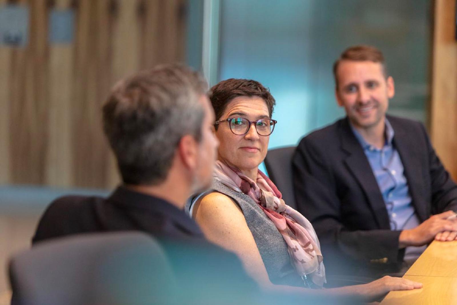 three people meeting in a meeting room
