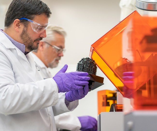 Two scientists are working on a 3D model in a lab
