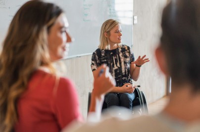 Confident disabled businesswoman giving presentation in office