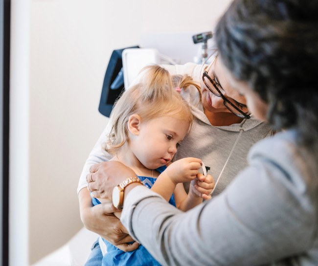 a girl with her mother consult with a doctor