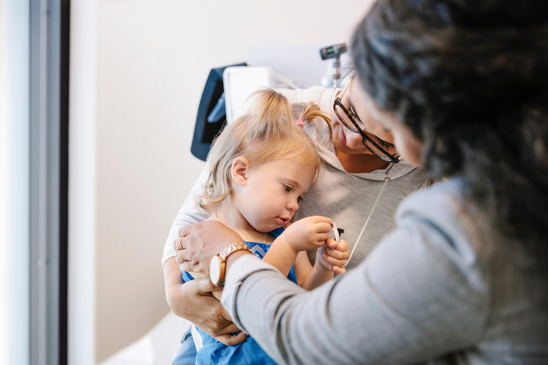 a girl with her mother consult with a doctor