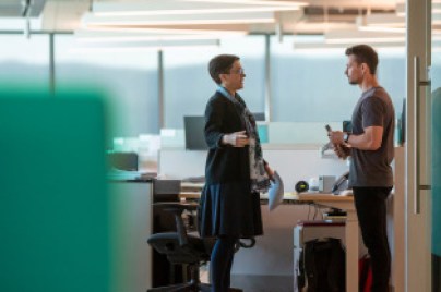 two men are talking in the office