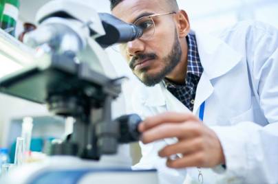 a scientist is using a microscope