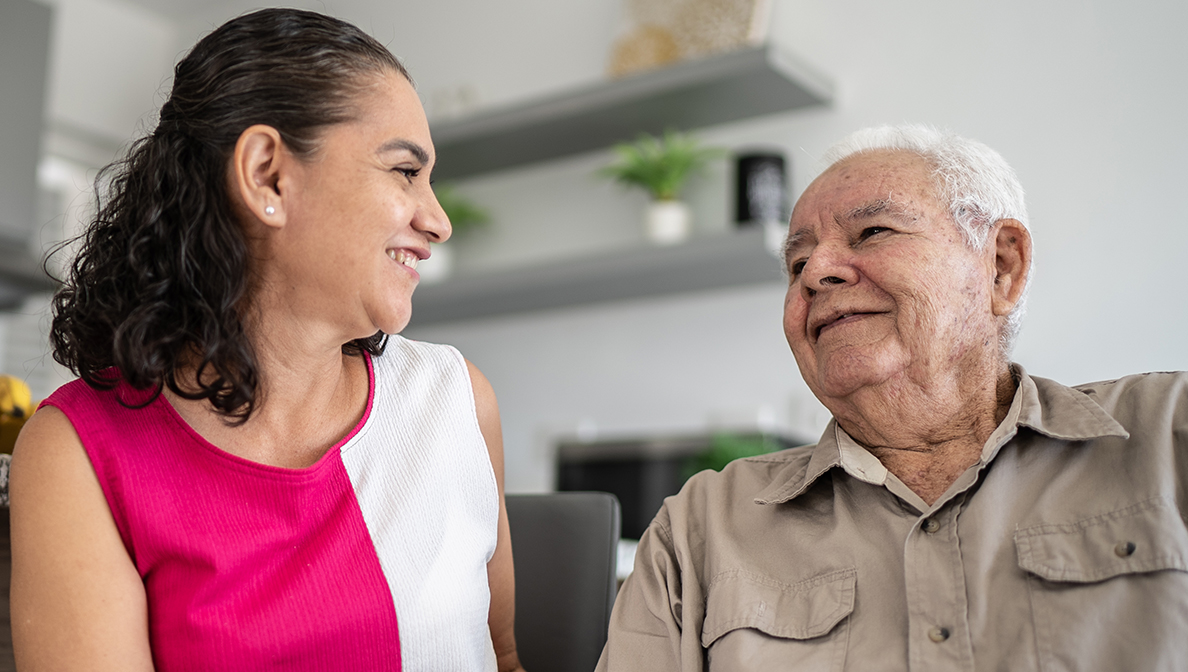 A woman talking to an older man.